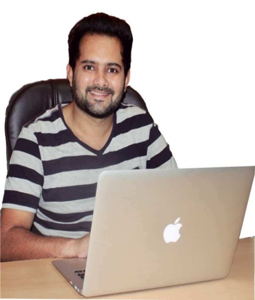 A freelance SEO expert in India working on an apple laptop.